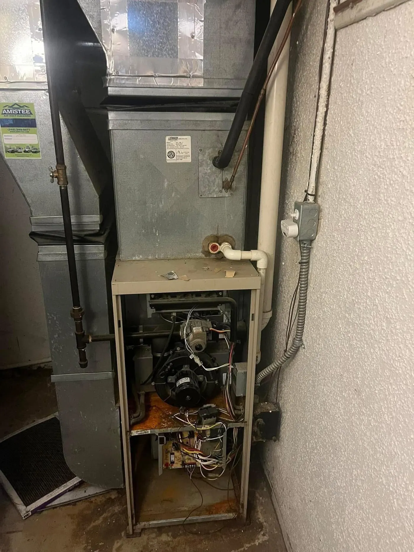 An older Lennox furnace with the panel off, showing the inducer motor, gas valve and control board